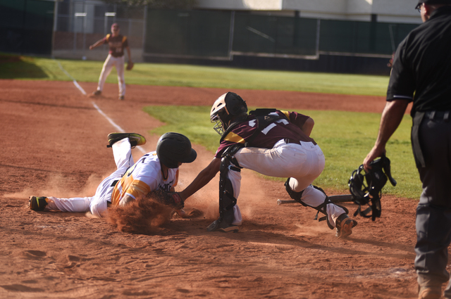 Pahrump Valley’s Willie Lucas (24) tags out Clark’s Zachary Graham (15) during t ...
