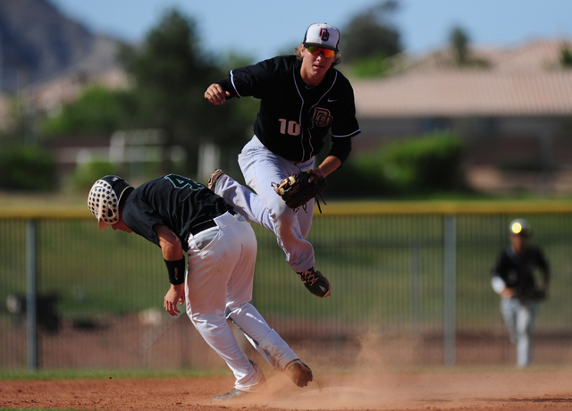 Palo Verde base runner Asher Bouldin (4) interferes with Desert Oasis shortstop Bryson Stott ...