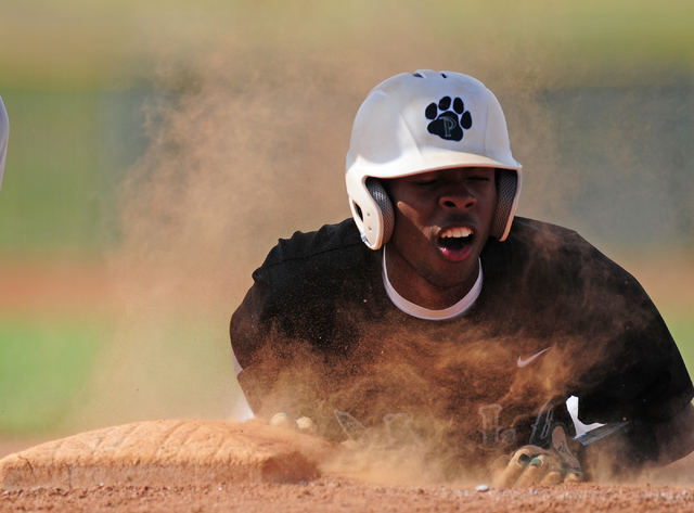 Palo Verde base runner Wesley Cosby dives back to first base as Desert Oasis checks the runn ...