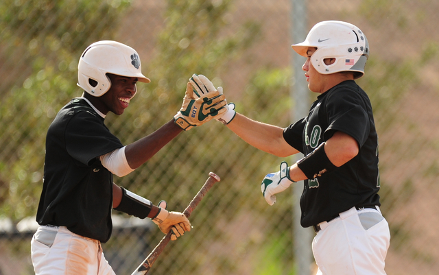 Palo Verde base runner Wesley Cosby, left, high fives Mitchell Rathbun at home plate after R ...