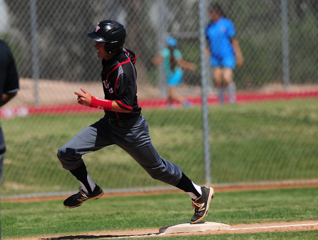 Las Vegas base runner Ryan Freimuth rounds third base to score in the first inning of their ...