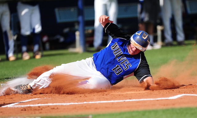 Basic base runner Jack Wold scores a run against Green Valley in the second inning of their ...
