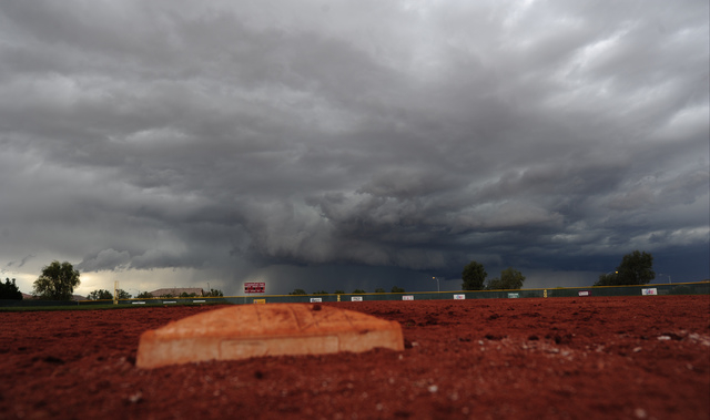 First base is seen while a thunderstorm approaches after a prep baseball game between Desert ...