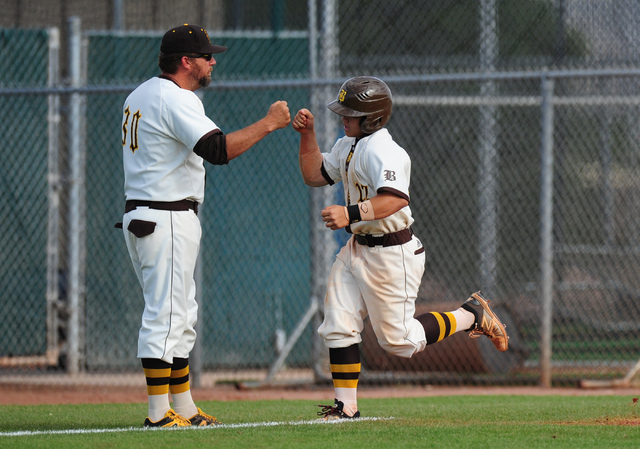 Bonanza baserunner Jay DeSoto high fives head coach Mike O’Rourke after hitting a two- ...