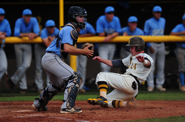 Bonanza baserunner Eric Schultz scores a run while Centennial catcher Hayden Grant awaits th ...