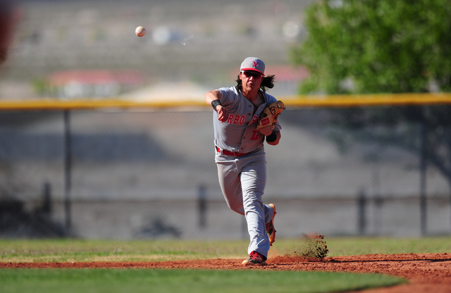 Arbor View shortstop Nick Quintana throws out a Shadow Ridge base runner at first base in th ...