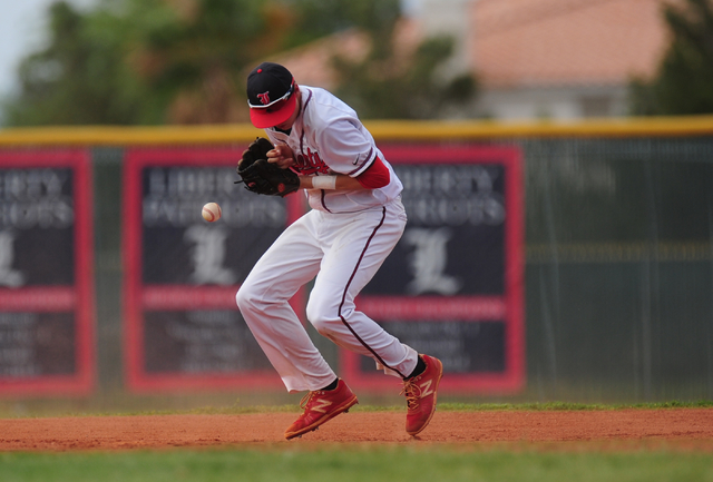 Liberty shortstop Jacob Rogers is unable to come up with a Silverado ground ball in the thir ...