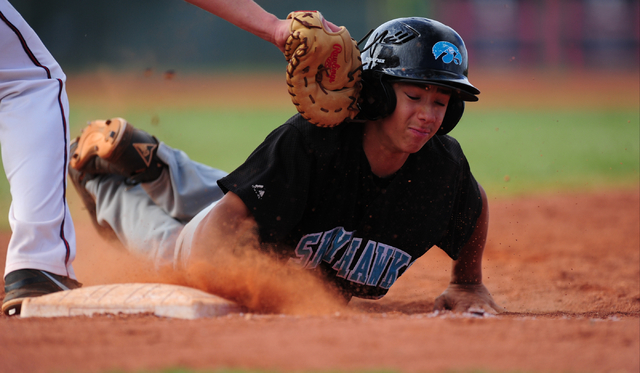 Silverado baserunner Dax Fellows is hit in the helmet by the glove of Liberty first baseman ...
