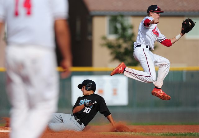 Silverado baserunner Chase Cortez steals second base while Liberty shortstop Jacob Rogers ju ...