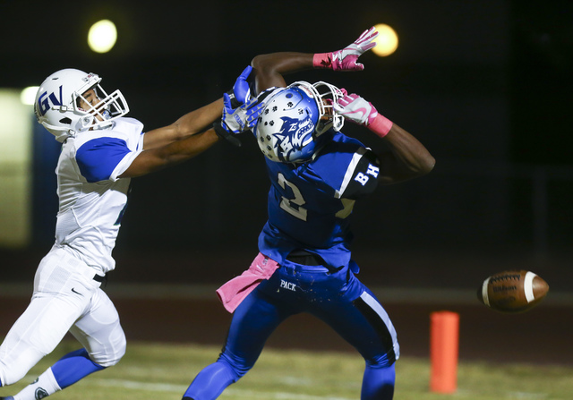 Basic’s DeShawn Eagles (2) misses a pass as Green Valleyճ Antoin Kealoha (6) defends ...