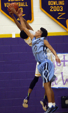 Canyon Springs guard Channel Banks (13) and Durango forward Michael Diggins go for the ball ...