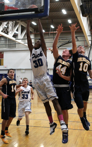 Basic forward Rob Sutton (30) goes up for a shot in front of Boulder City forward Brooks Roe ...