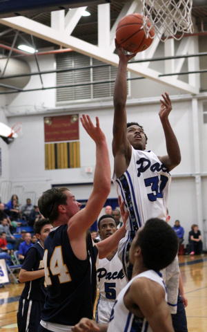 Basic forward Rob Sutton (30) goes up for a shot over Boulder City forward Brooks Roe (44) i ...