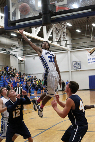 Basic forward Rob Sutton (30) goes up for a rebound between Boulder City’s Quentin Tur ...