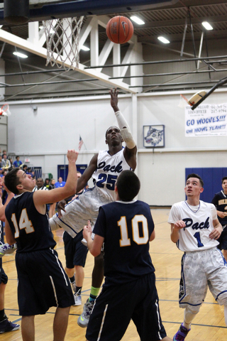 Basic forward Josh Villaros (25) shoots over Boulder City guard/forward Trenton Carmel (14) ...
