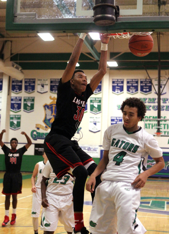 Las Vegas forward Tyler Bey (30) dunks in front of Green Valley shooting guard Xavier Jarvis ...