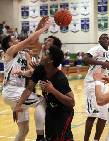 Green Valley shooting guards Brandon Burke (10) and Xavier Jarvis (4) and Las Vegas point gu ...