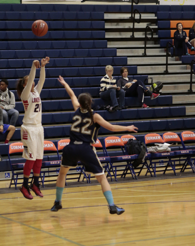 Liberty High School’s Kaily Kaimikaua (21) shoots a jumper over Skyline’s Kyla P ...