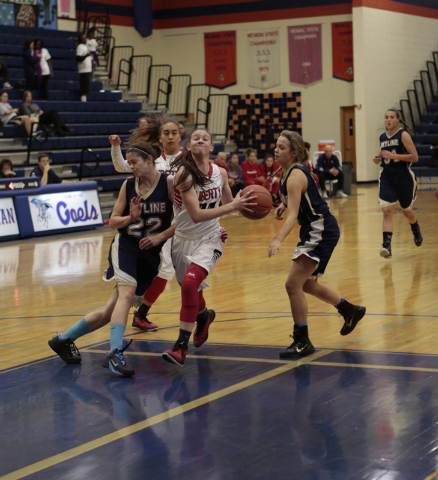 Liberty’s Kealy Brown (20) goes in for a layup during the first half on Thursday. (Don ...