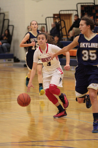 Liberty’s CeCe Quintino (3) brings the ball down the curt during the first half agains ...