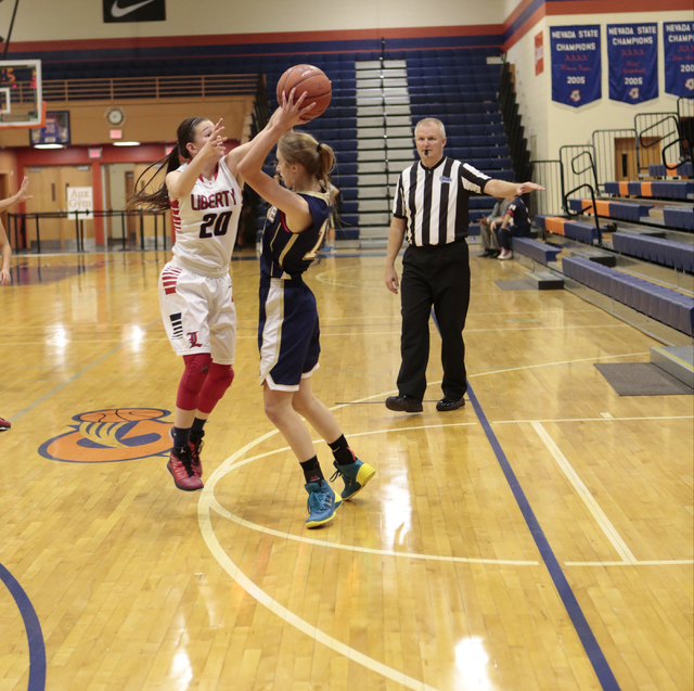 Liberty’s Kealy Brown (20) defends Skyline’s Hannah Anderl (15) during the secon ...