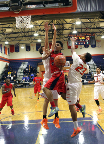 Findlay Prep guard Allonzo Trier (4) goes up for a shot between Wasatch Academy forward/cent ...
