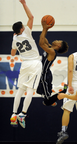 The Meadows School guard Jake Epstein (23) defends Agassi Prep guard Kobe Williams in the se ...