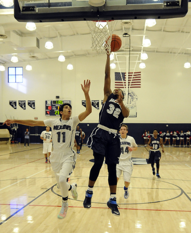 Agassi Prep forward Kenneth Hatano (32) scores on a layup as The Meadows School guard Ashees ...
