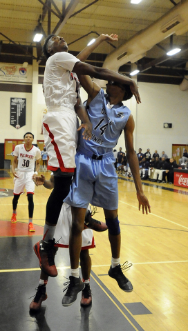 The arm of Las Vegas High guard Deshawn Weathers, left, knocks the glasses off of Canyon Spr ...