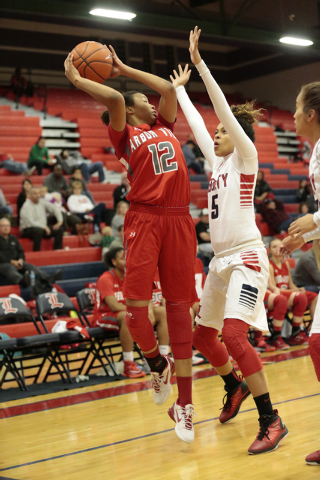 Arbor View’s Ariona Gill (12) looks to pass the ball over Liberty’s Jaelyn Royal ...