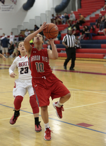Arbor View’s Tiffani Smith (10) makes a layup as Liberty’s Alexis Tomassi (23) l ...
