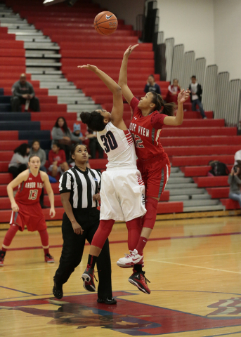 Liberty’s Paris Strawther (30) and Arbor View’s Ariona Gill (12) reach for the b ...