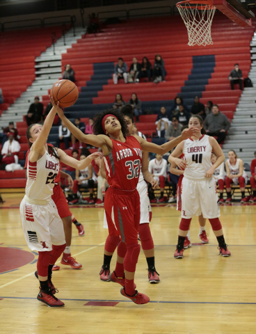 Liberty’s Kealy Brown (20) blocks a shot by Arbor View’s Janae Strode (32) durin ...