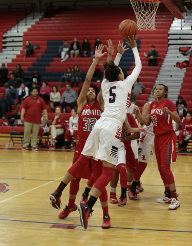 Liberty’s Jaelyn Royal (5) takes a shot as Arbor View’s Janae Strode tries to de ...