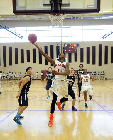 Agassi Prep guard Deishuan Booker (11) goes up for a layup against The Meadows earlier this ...