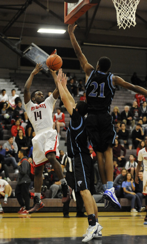Las Vegas guard Deshawn Weathers (14) attempts a shot while being defended by Foothill forwa ...