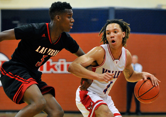 Valley’s Taveon Jackson, right, brings the ball down court against Las Vegas’ Ty ...