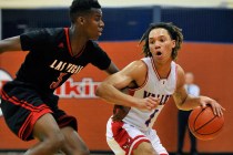 Valley’s Taveon Jackson, right, brings the ball down court against Las Vegas’ Ty ...