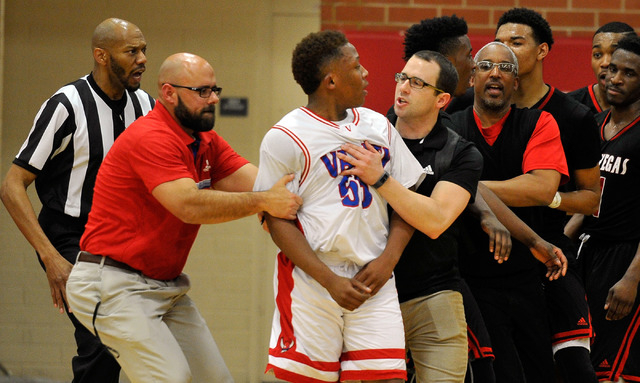 Valley’s Darrion Daniels, center, is led away after he was involved in a scuffle with ...
