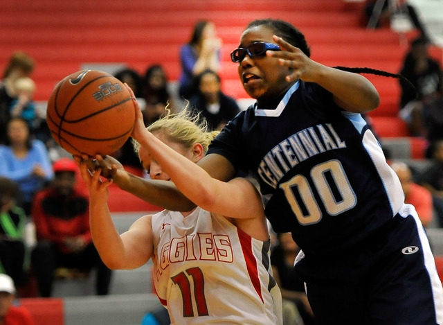 Arbor View’s Kelsey Rasore and Centennial’s Tanjanae Wells vie for a rebound on ...