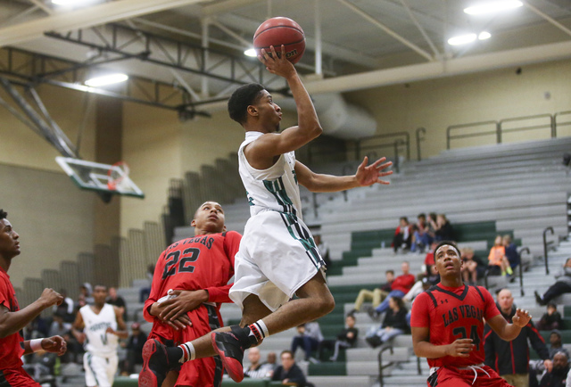 Rancho guard Keith Davis (2) sends in a shot to score against Las Vegas during a basketball ...