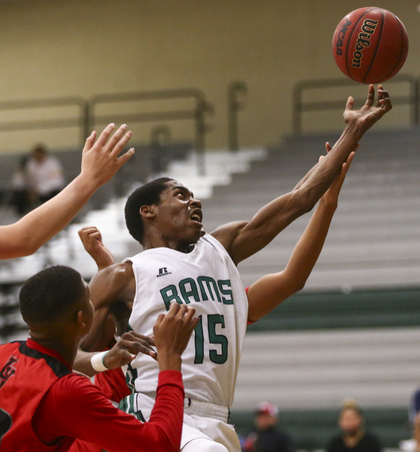 Rancho’s Justin Holiday (15) reaches for a rebound over Las Vegas during a basketball ...