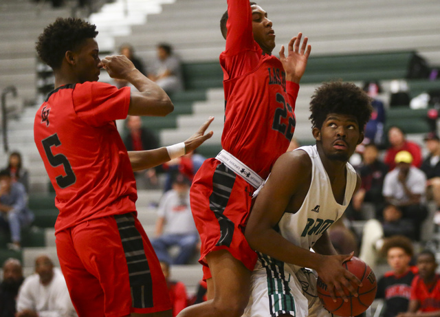 Las Vegas guard Deondre Northey (5) and forward Zion Edwards (22) defend as Rancho forward S ...