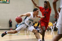 Rancho guard Chrys Jackson (3) drives against Las Vegas guard Deondre Northey (5) during a b ...