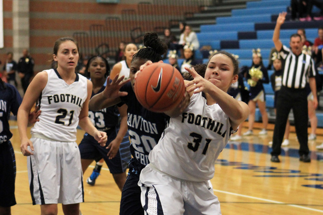 Foothill’s Bri Rosales grabs a rebound from Canyon Springs’ Alexia Thrower on Tu ...