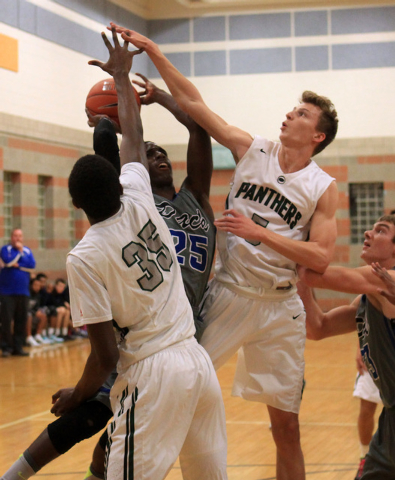 Palo Verde’s Jamell Garcia-Williams, left, and Grant Dressier defend Basic forward Jos ...