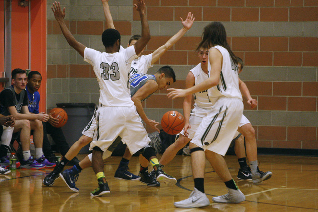 Basic guard Chaz Lucero finds himself surrounded by Palo Verde players at the Foothill Holi ...