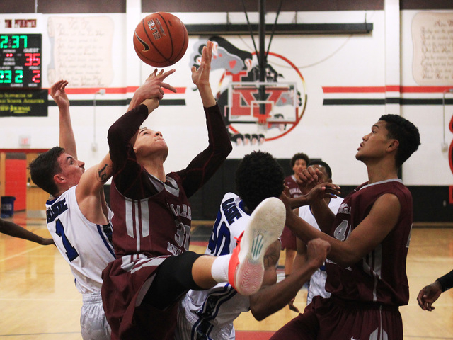 Basic guard Jared Meacham and Cimarron-Memorial center Joe Tito compete for a rebound during ...