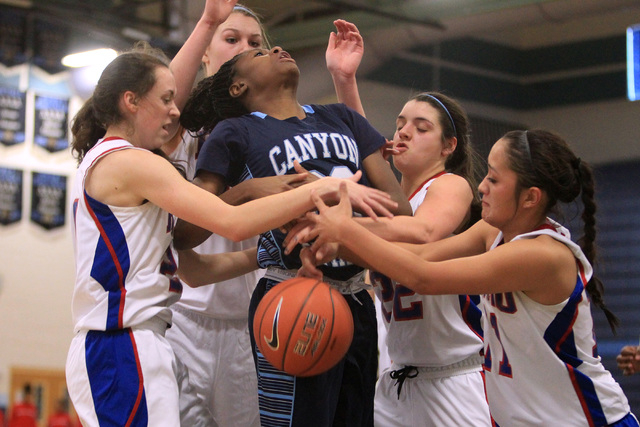 Canyon Springs guard Alexia Thrower looses the ball to Reno players, from left, Megan Dericc ...