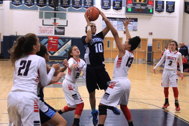 Centennial guard Jayden Eggleston drives the lane for the winning basket against Liberty dur ...